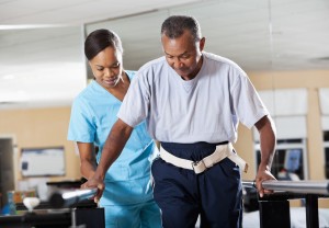 A man undergoing a physical therapy with an aid of an expert surgeon